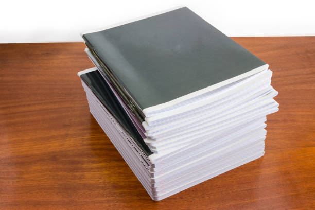istock Stack of the different exercise books on wooden table 1043503046