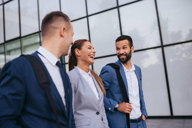 istock Three business colleagues having discussion while walking outdoors 1043503470