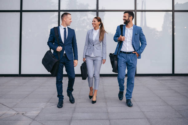 istock Three business colleagues having discussion while walking outdoors 1043506180
