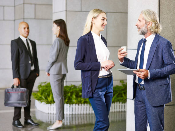 istock corporate executives standing talking in company lobby 1043514878