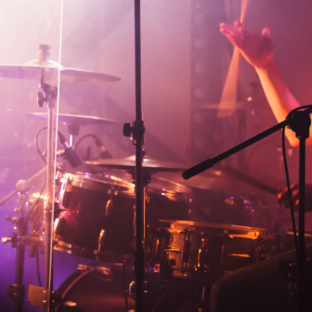 istock Hand with drumsticks near rock drum set 1043517988