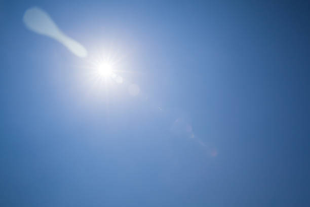 istock Lens flare effect over clear sky with shining sun 1043519658
