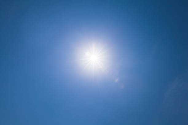istock Lens flare effect over blue sky with sunlight 1043519662