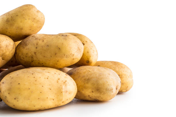 istock A pile washed potatoes isolated on white background. 1043523906