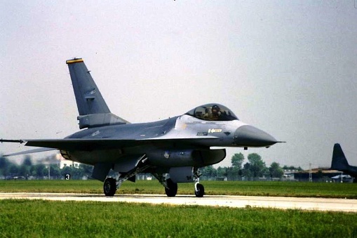 A F 16 military fighter plane on the runway