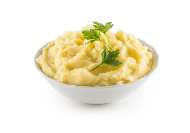 Photo of Mashed potatoes in bowl isolated on white background.