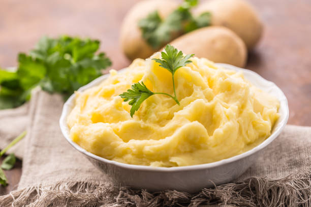 istock Mashed potatoes in bowl decorated with parsley herbs. 1043524226