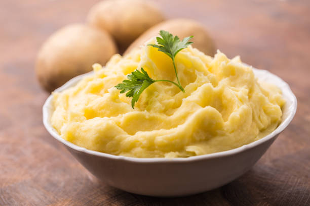 istock Mashed potatoes in bowl decorated with parsley herbs. 1043524250