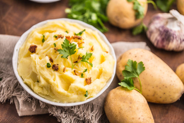 istock Mashed potatoes in bowl decorated parsley herbs and roasted bacon pieces. 1043524292