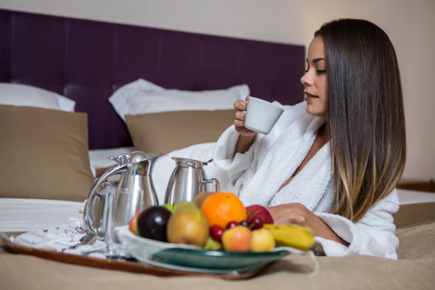 istock Young woman drinking coffee in bed 1043528326