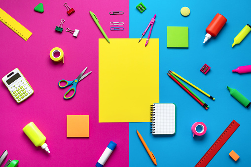 Office supplies on a multi-colored background