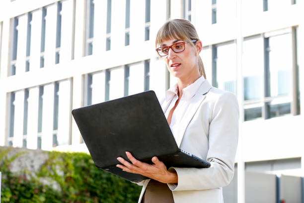 istock Woman works outside on the computer 1043533290