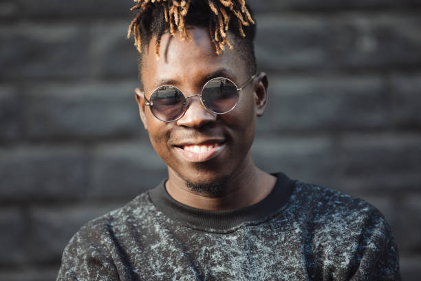 istock Smiling cool african american man with dreadlocks and glasses 1043535636