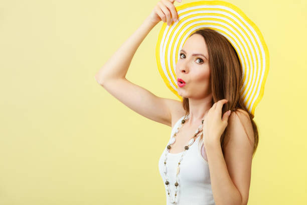 istock Woman in big yellow summer hat. 1043542636