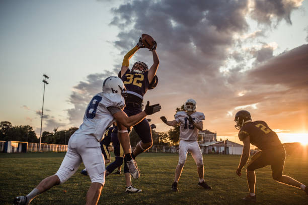 istock Tackling an offensive player at sunset! 1043542696
