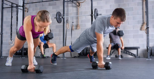 istock Instructor and young woman doing push-ups 1043542908