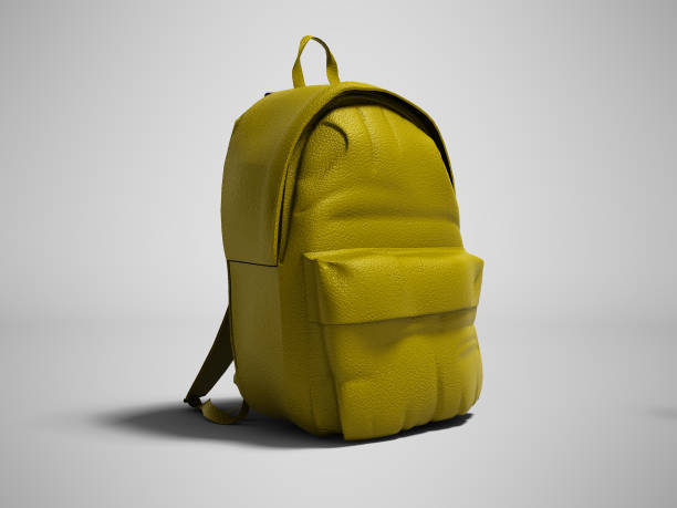 istock Modern yellow leather backpack in school for children and teens left view 3D rendering on gray background with shadow 1043547052