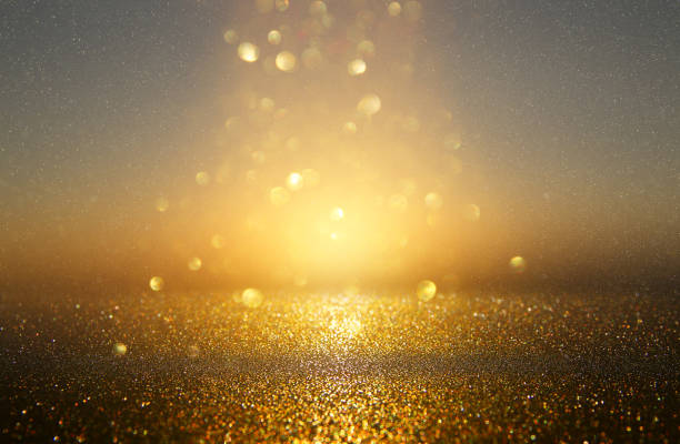 istock glitter vintage lights background. black and gold. de-focused. 1043547252