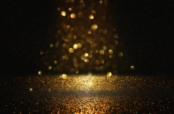 istock glitter vintage lights background. black and gold. de-focused. 1043547372