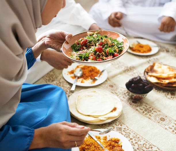 istock Muslim family having dinner on the floor 1043553618