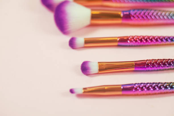 istock Set of mermaid tail make-up brushes. Make up tools on pastel backg 1043553624