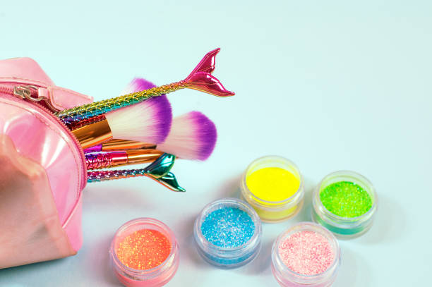 istock Set of mermaid tail make-up brushes. Make up tools on pastel backg 1043554202