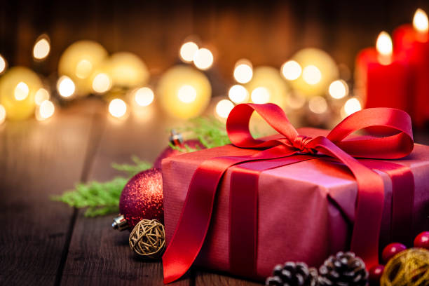 istock Red Christmas gift box on rustic wooden table 1043554532