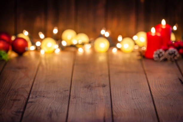 istock Empty rustic wooden table with Christmas lights at background 1043554684