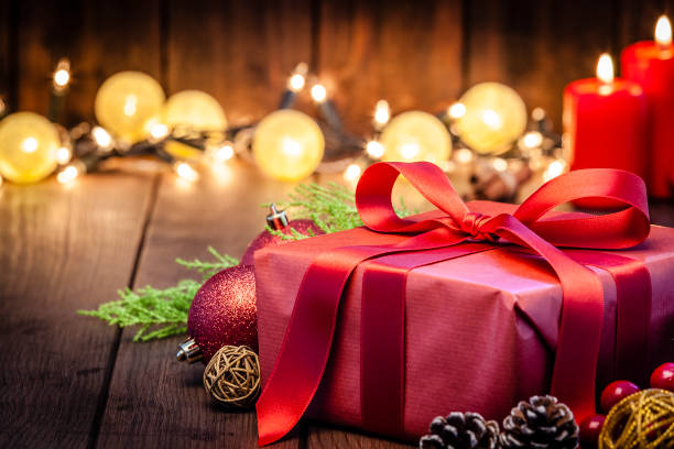 istock Red Christmas gift box on rustic wooden table 1043554690