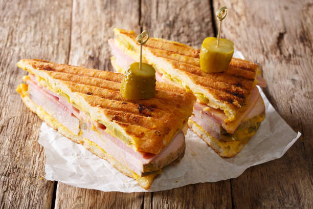 istock Cuban sandwich with ham, mustard, cheese, pickled and pork close-up. horizontal 1043554836