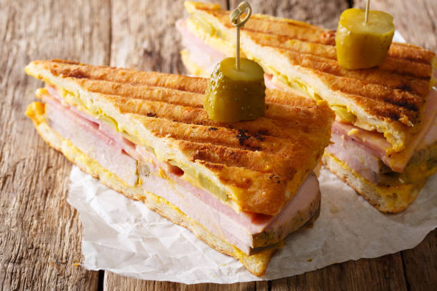 Sliced Cuban sandwich close-up on paper on a table. horizontal