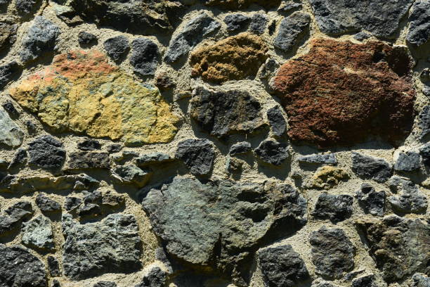 Volcanic rocks in various colors, sizes and shapes used in a rustic wall held together with cement. Photo taken in the Troodos mountains of Cyprus. Nikon D7200 with 200mm lens.