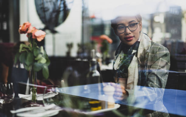 istock Young asian female thinking and looking through window. 1043561392