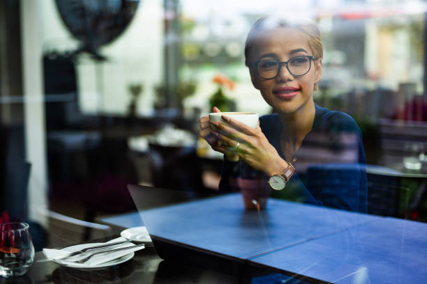 istock Young asian female student drinking cappuccino in restaurant. 1043561440