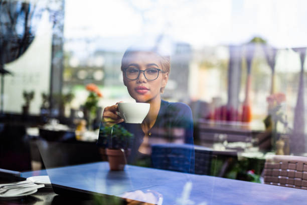 istock Young asian female student drinking tea in restaurant. 1043561498