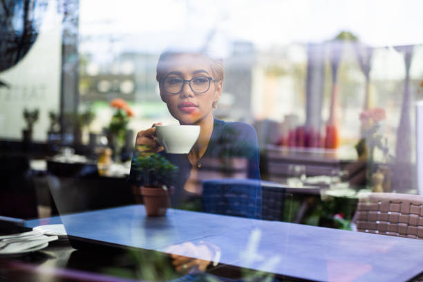istock Young asian female student drinking coffee in restaurant. 1043561682