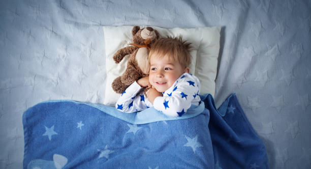 istock three years old child sleeping in bed 1043561964