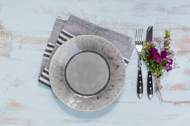 istock Rustic table setting with purple flowers on light wooden table. 1043565320