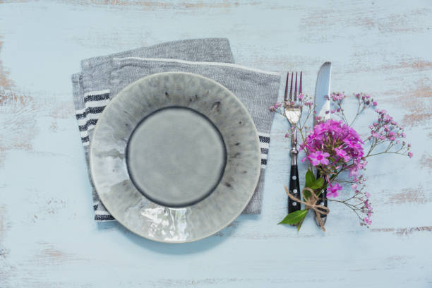 istock Rustic table setting with pink flowers on light wooden table. 1043565340