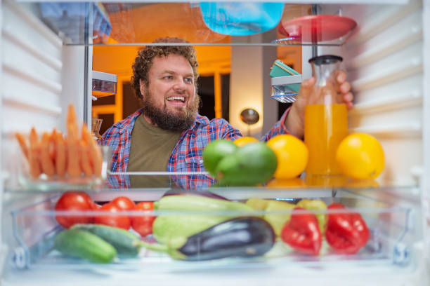 istock Man taking food late at night. 1043566866