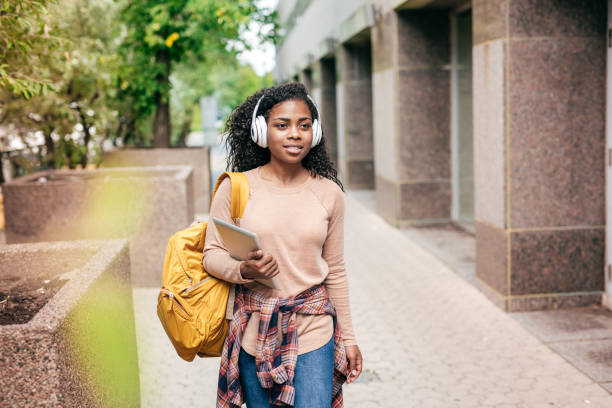 istock International student with backpack, headphones and digital gadgets 1043568548