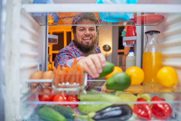 istock Man taking food at night. 1043569398