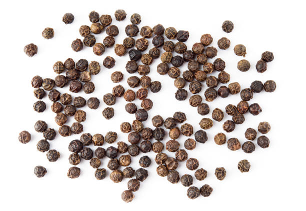 istock Black pepper. Peppercorns isolated on white background. Macro. Top view. 1043572652