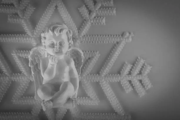 Christmas guardian angel and snowflake, black and white composition