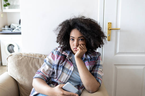 istock Sad african woman social networking at home 1043573766