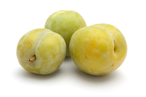 Greengages, a plum cultivar, isolated on a white background.