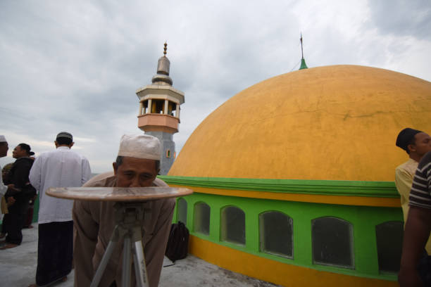 Surabaya, Indonesia - May 16, 2018: Religious officials are looking for moon (the moon's son) through a traditional tool specifically to determine the direction of the fasting month in Al-Mabrur Mosque, Surabaya, Indonesia