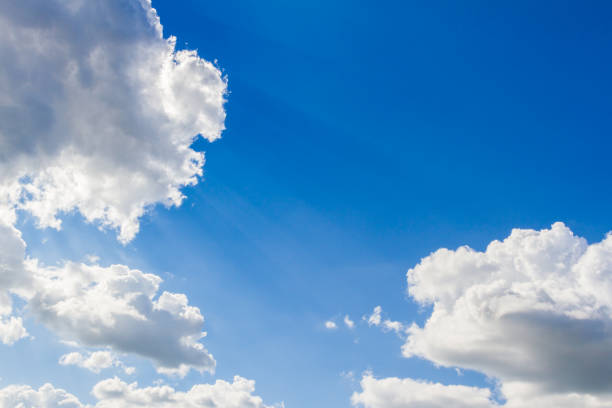istock Blue sky with clouds and sun reflection in water in the clouds 1043584444