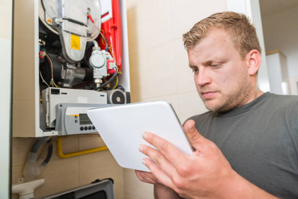 istock Technician repairing Gas Furnace using digital tablet 1043589318