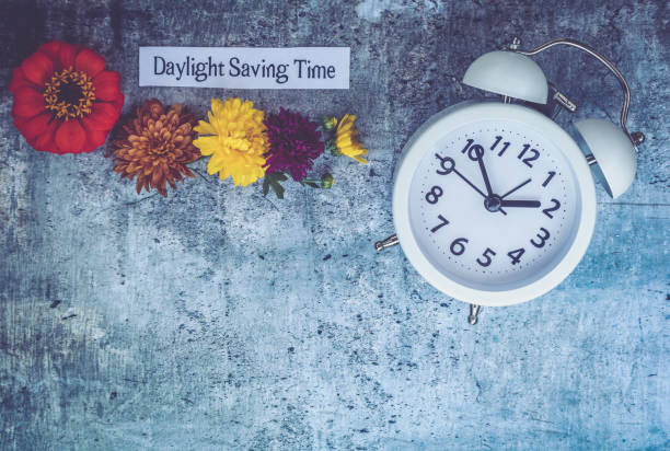 istock Fall Daylight Saving Time concept with white clock and flowers, flat lay 1043592606